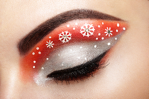 Eye girl makeover snowflakes. Winter christmas makeup. Beauty fashion. Eyelashes. Cosmetic Eyeshadow. Makeup detail. Creative woman holiday make-up
