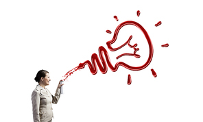 Young businesswoman spraying idea bulb from aerosol balloon