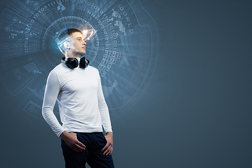 Young handsome man against media backdrop wearing headphones