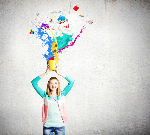 Young girl holding bucket with colorful splashes