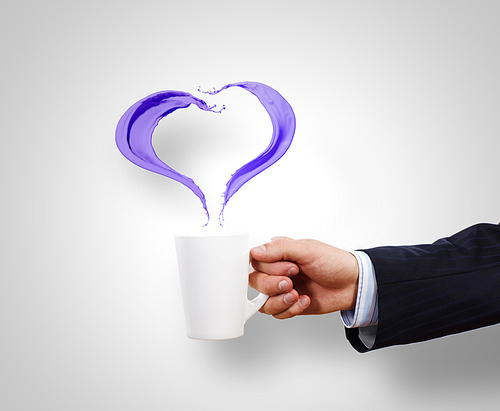 Businessman holding white cup with splashes in hand