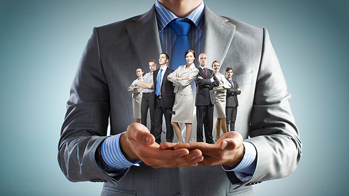 Close up of businessman holding in hands successful business team