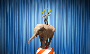 Young businessman in cap standing on elephant and juggling with balls