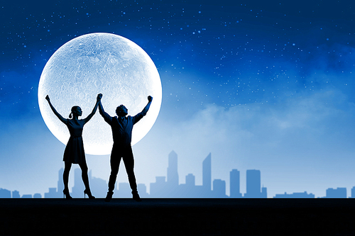 Silhouettes of young couple against full moon