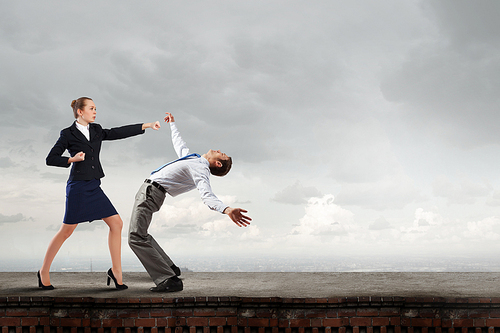 Two businesspeople in anger fighting with each other