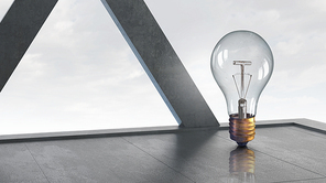 Glass light bulb against office room with large window