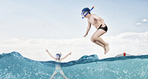 Kid boy of school age in diving mask jumping in water