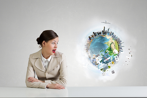 Emotional attractive businesswoman sitting at table in office. Elements of this image are furnished by NASA