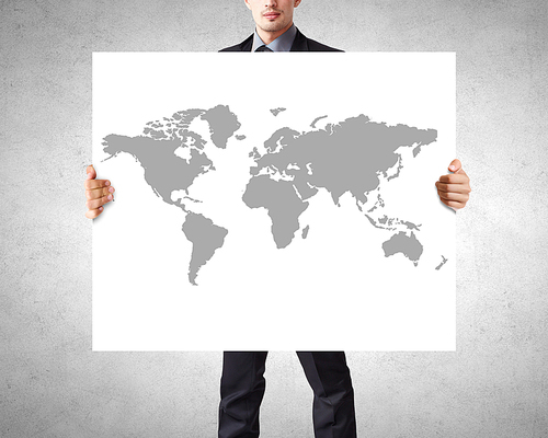 Businessman showing banner with world map concept
