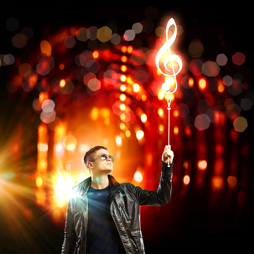 Image of young man rock musician in lights