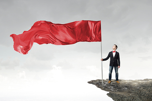 Young student guy with color blank waving flag