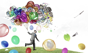 Young funny man in hat with balloons presenting celebration concept. Elements of this image are furnished by NASA