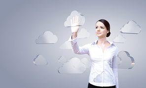 Attractive businesswoman touching cloud icon on screen