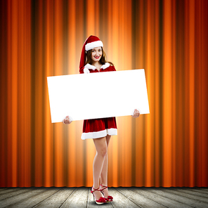 Girl in Santa costume with white blank banner. Place for text