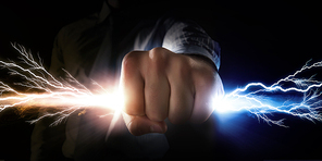 Close up of businessman grasping light in fist