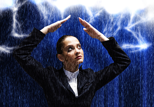 Young businesswoman protecting her head from rain with hands