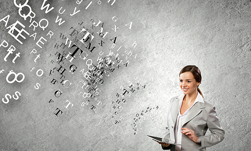 Young attractive woman in suit with tablet pc in hands