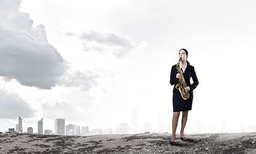 Young woman in suit with saxophone in hands