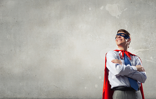 Young man in superhero costume representing creativity concept