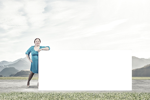 Stout confident woman of middle age with blank white banner