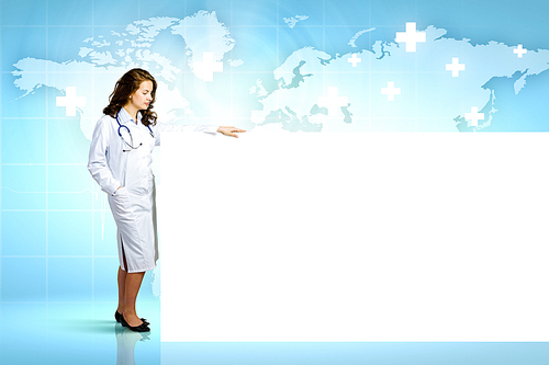 Image of young female doctor with blank banner. Place for text