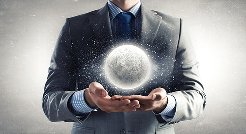 Close up of businessman holding moon planet in palms