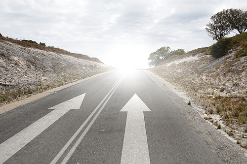 Image of road and arrow on asphalt pointing direction