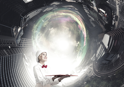 Young woman in white cylinder and red bowtie with book in hands