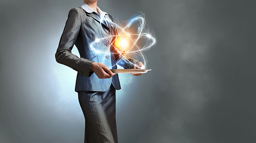 Close up of businesswoman holding glowing atom in hands