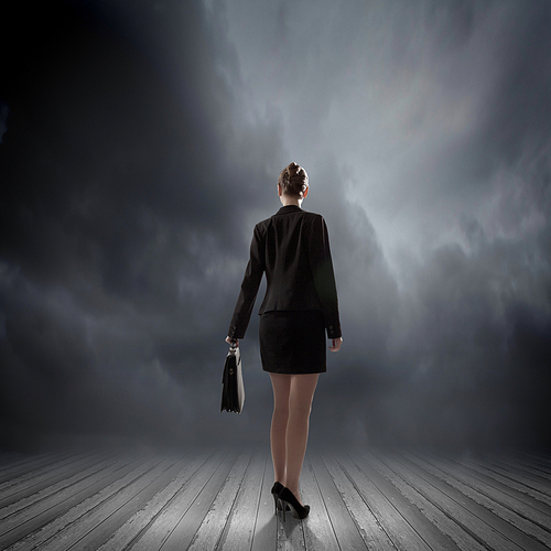 Rear view of businesswoman standing in lights of stage