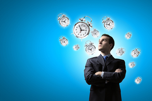 Image of young businessman and pocket watch. Time concept