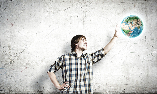 Young man touching image of Earth planet. Elements of this image are furnished by NASA