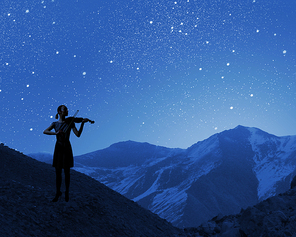 Silhouette of woman playing violin at night