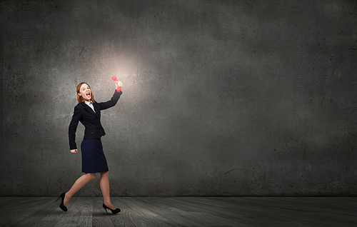 Young businesswoman with red phone receiver in hands