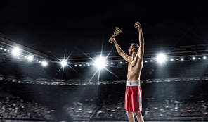 Professional boxer on arena in spotlights celebrating victory mixed media