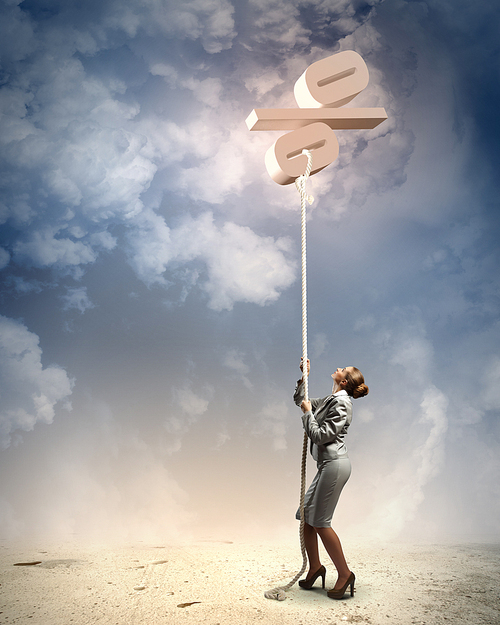 Image of businesswoman climbing the rope attached to percentage sign