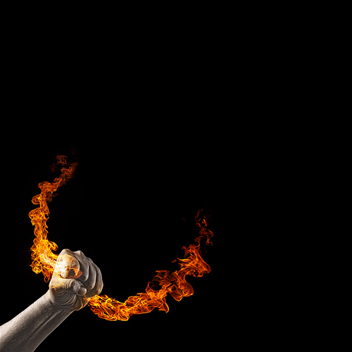 Close up of human hand holding fire flame