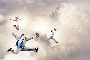 Image of happy business people jumping high in sky