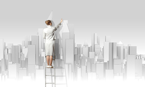 Businesswoman standing on ladder with back and drawing project of city