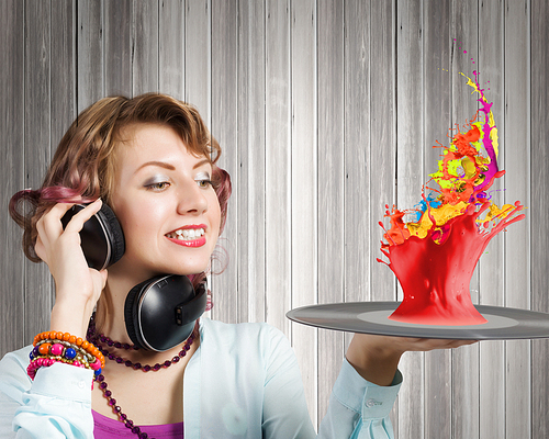 Young woman in casual wearing headphones and holding disco plate