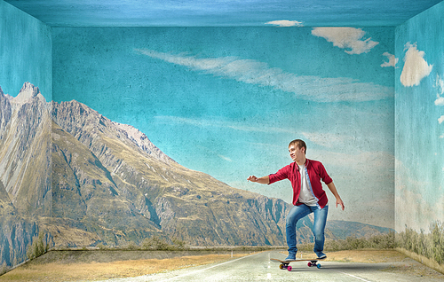 Handsome teenager cool acive boy riding skateboard