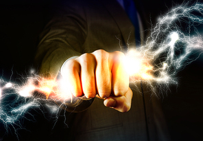 Close up of businessman grasping lightning in hand