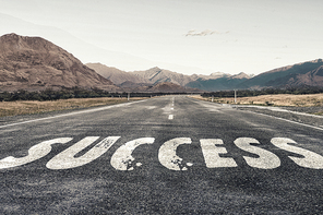 Conceptual image with word success on asphalt road