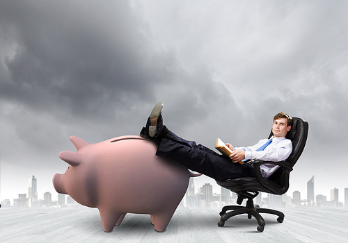 Young handsome businessman sitting in chair. Banking concept