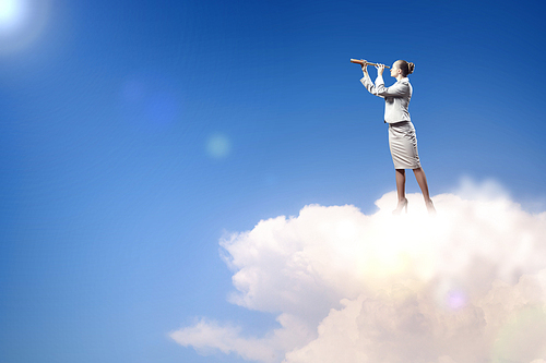 Image of businesswoman looking in telescope standing atop of rock