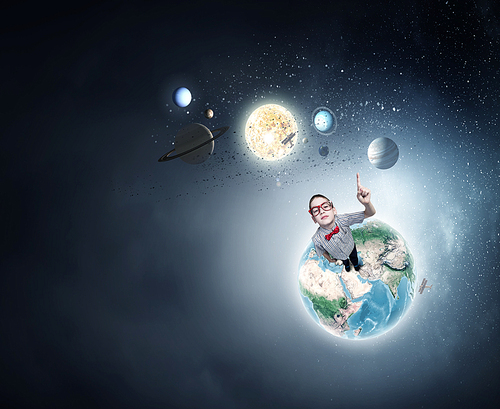 Cute schoolboy in red glasses with finger pointing up. Elements of this image are furnished by NASA