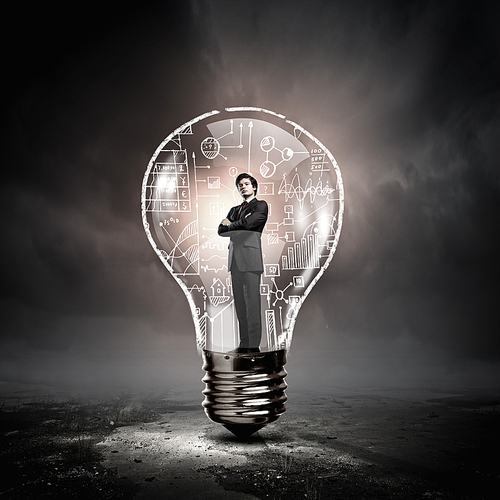 Man holding luminous idea inside light bulb
