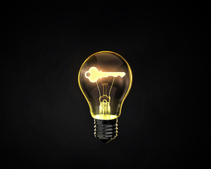 Light bulb with key inside on dark background