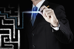 Close up of businessman drawing way out of labyrinth