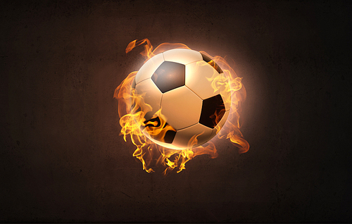 Conceptual image of football ball in fire flames